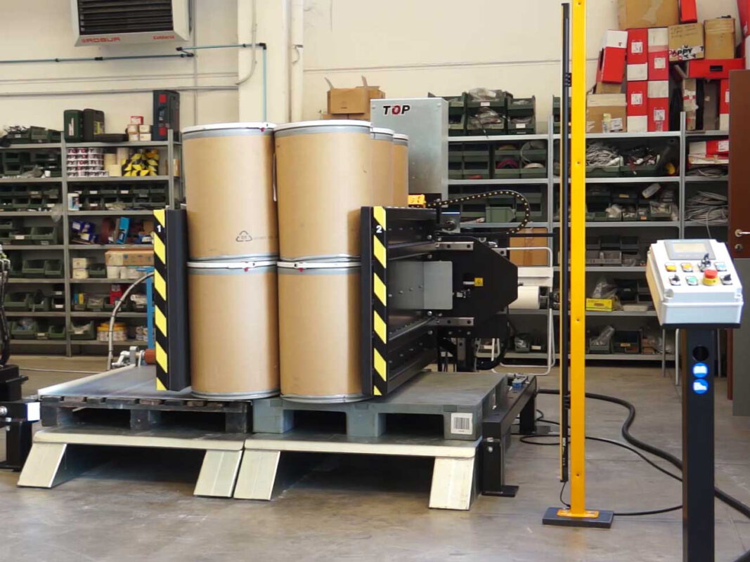 stationary pallet changer side mover with cardboard drums